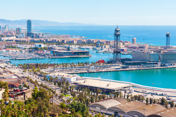 Obraz premium Cable car against the background of the city of Barcelona. View from Montjuic mountain to the city and Yacht port.