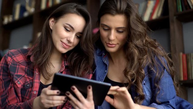 Two female friends with tablet computer