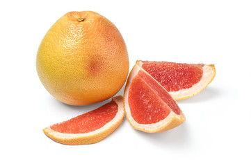 Whole grapefruit and wedges on white