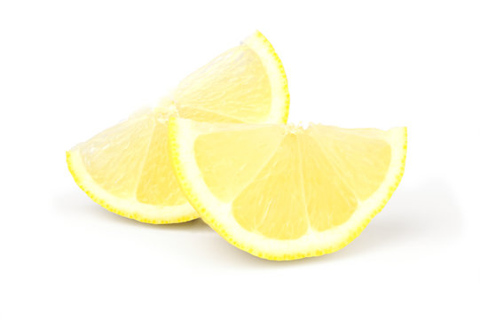 Two Wedges Of Fresh Lemon On White Background