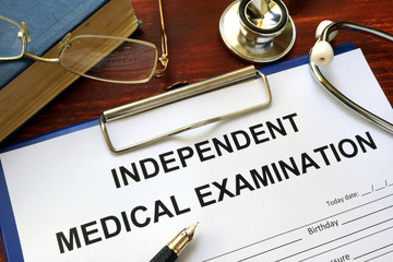 Independent Medical Examination (IME) form on a wooden table. - obrazy, fototapety, plakaty