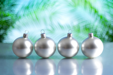 Silver baubles on nature background