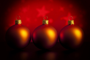 Three baubles on red background