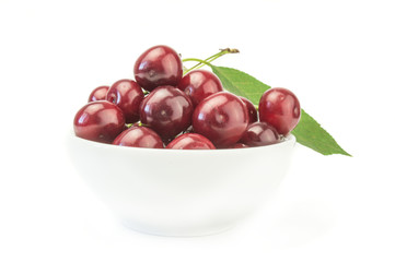 Bright cherry in the bowl with leaf