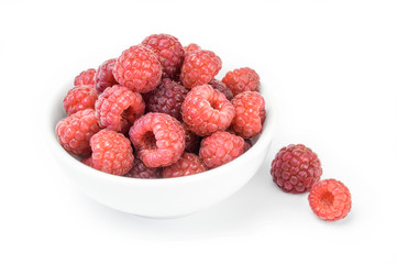 Raspberries in a bowl isolated on white background