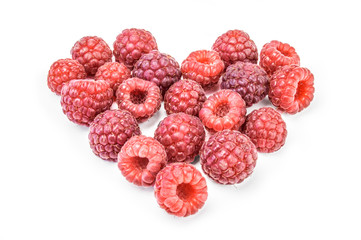 Heart shaped red raspberries on white background