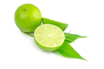 Two halves and whole lime isolated on white with leaves