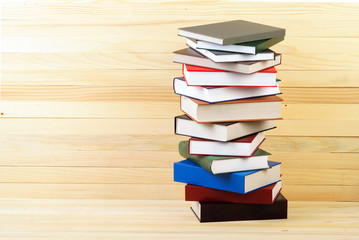 Stack of hardback books on wooden table. Back to school. Copy space
