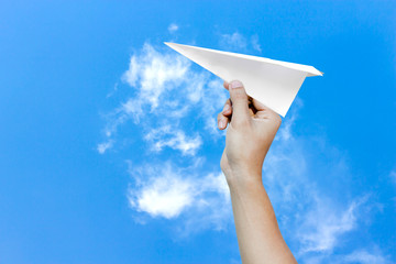 paper aero plane ready to take off as a conceptual picture on blue background