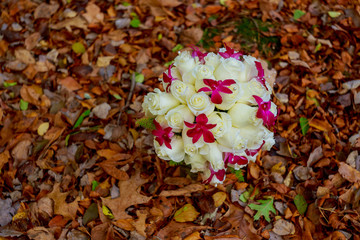 Bridal bouquet of white roses on a background  leaves