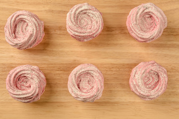Marshmallows. Pink. Sugar powder. On the Board.