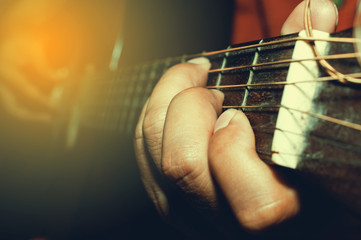 playing acoustic guitar close-up