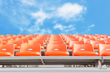 Naklejka premium Orange empty stadium seats in arena