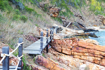 wood walk way bridge on the rock sea shore