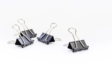 Black metal paperclips on white background
