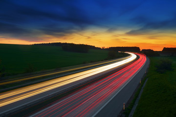 Long-exposure sunset over a highway