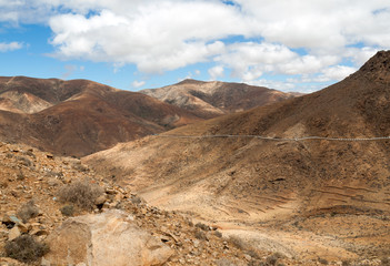 Beautiful volcanic mountains and the road on a mountain slope.  Road from la Pared to Betancuria . Fuerteventura. Canary Islands