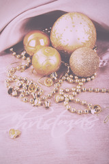 Festive gold Christmas decorations on fabric background Vintage