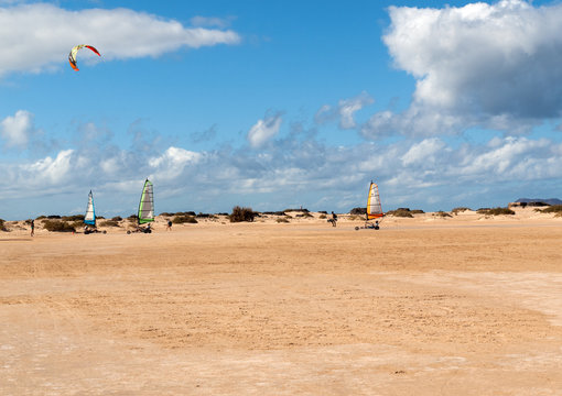  People driving sand yachting on the beach. They are learning and having fun.Corralejo, Fuerteventura