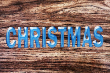 word christmas on wooden background