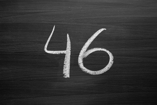 number forty six enumeration written with a chalk on the blackboard