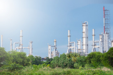 Fototapeta na wymiar Oil refinery along daytime with blue sky