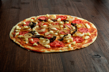 Pizza margarita on wood background.