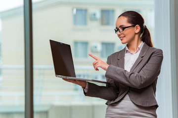 Businesswoman with laptop in business concept
