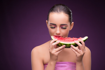 Beautiful woman eating tasty watermelon