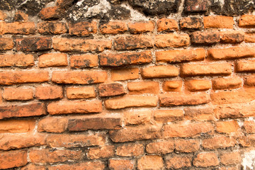 old brick wall with crumbling bricks