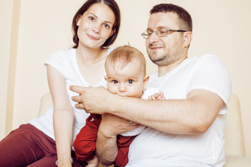 young happy modern family smiling together at home. lifestyle people concept, father holding baby...