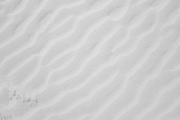 Fototapeta na wymiar White sand texture for background with diagonal lines.