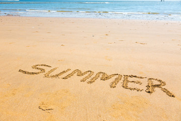 Summer word written on sand