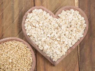 Oats and heart on wooden background