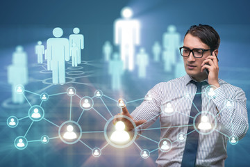 Young man talking on mobile in social networks concept