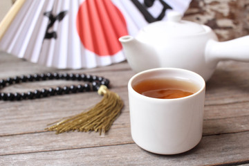 Tea pot and cup with paper fan