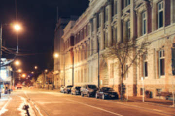 Naklejka na ściany i meble Blurred background - Street night city lights blur. Retro toned photo, Vintage filtered image.