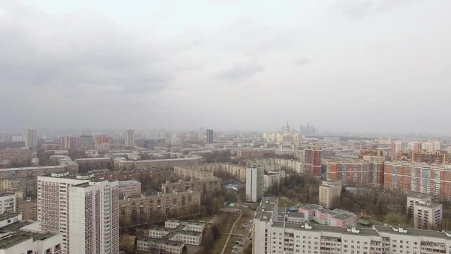 Aerial view of one of the districts of Moscow. Rainy April weather, cloudy and foggy. Moscow state University and Moscow city in the distance. Urban cityscape from quadrocopter
