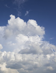 Naklejka na ściany i meble Cumulonimbus clouds against the blue sky
