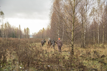 reaching hunters in camouflage