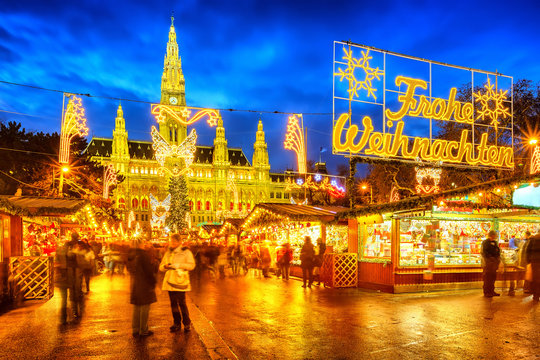 Traditional christmas market with 'Merry Christmas' sign in Vienna, Austria