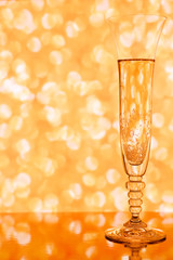 Champagne glass against golden blurred background © eshma