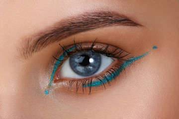 Blue eyes. Eye makeup. Beautiful eyes make-up. Holiday makeup detail. Long eyelashes. Close-up shot of female eye make-up
