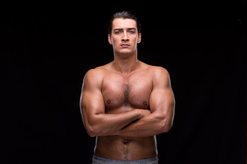 Fototapeta premium Ripped muscular man on black background