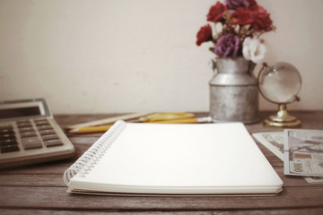 Blank notepad and dollar on office table