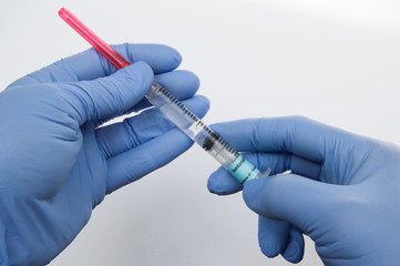Two Gloved Hands Holding Syringe Containing Fentanyl