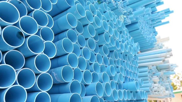 PVC pipes stacked in warehouse.