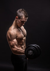 Fototapeta na wymiar side view, profile young bodybuilder arm dumbbell exercise