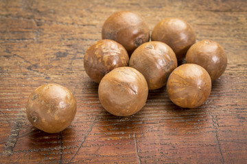 macadamia nuts on rustic wood