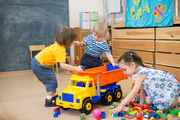 two kids conflict for toy truck in kindergarten